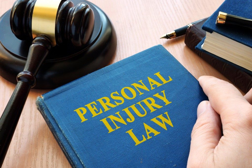 Personal injury law book beside gavel