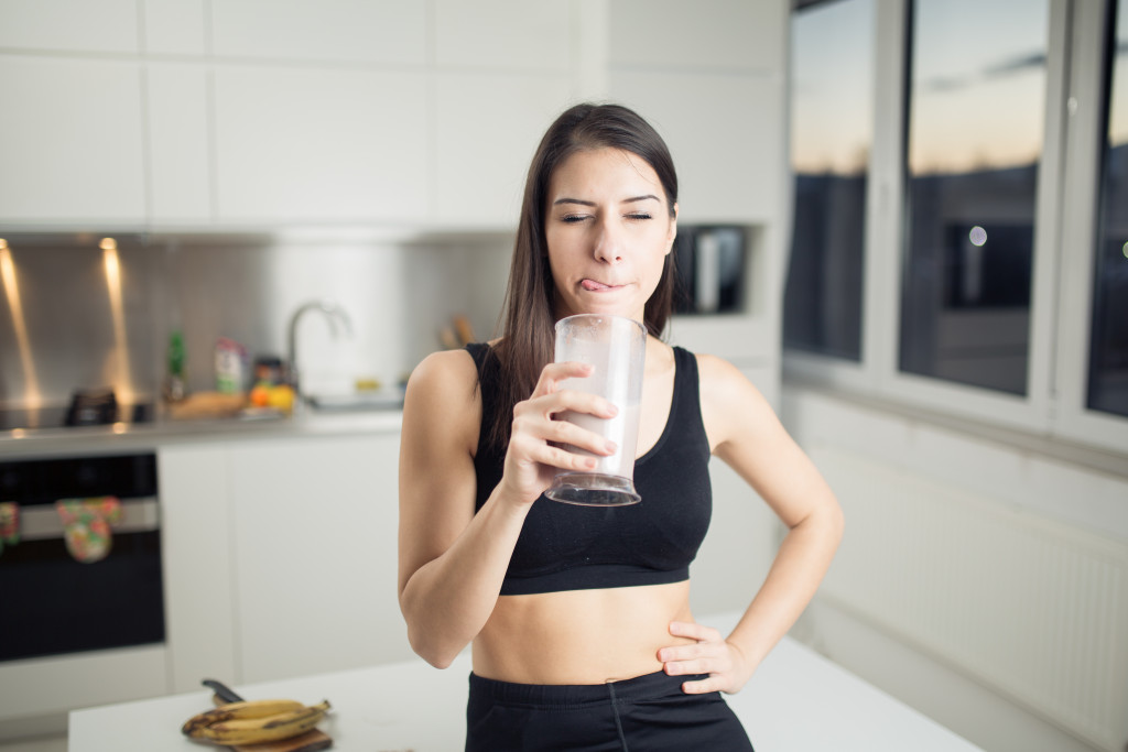 healthy looking woman taking a drink
