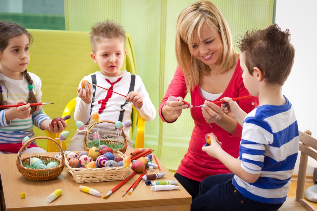 Children creating a project with their teacher