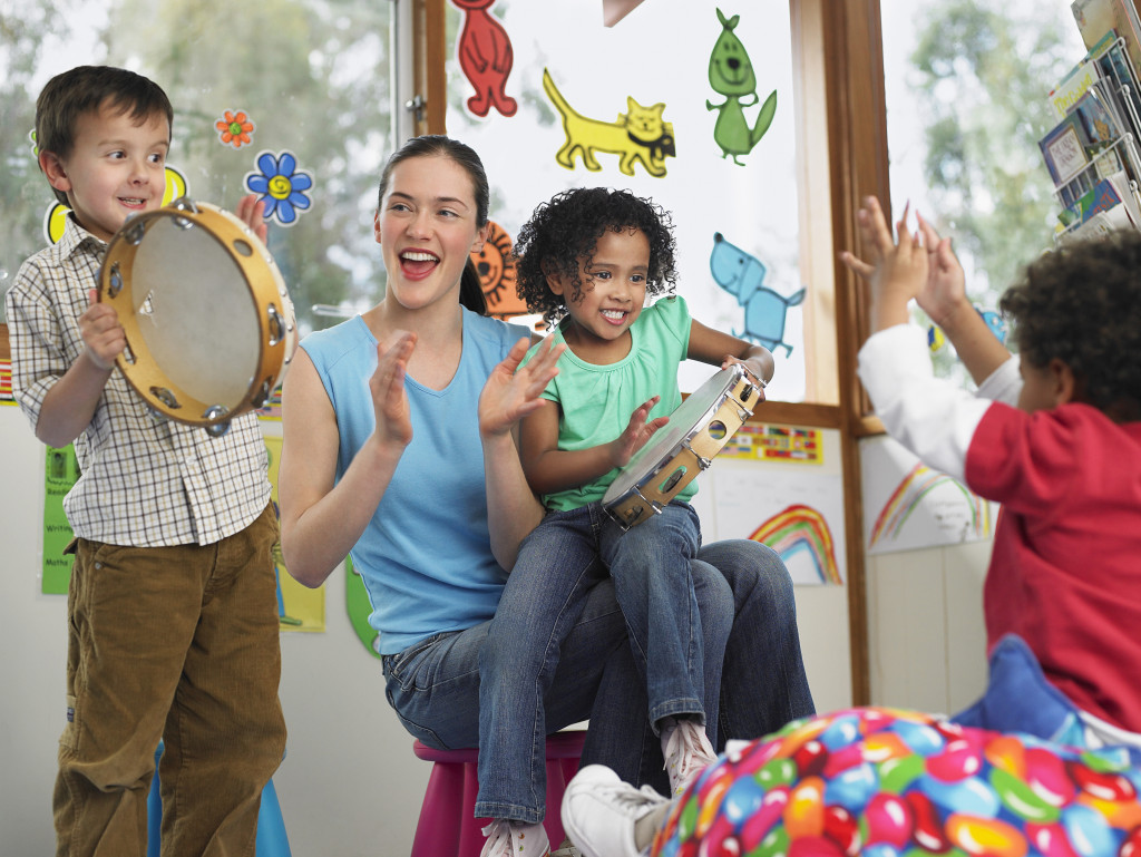 a teacher teaching gradeschoolers using music