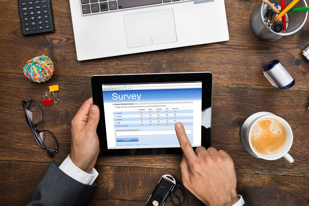 A businessman filling out an online survey form on a tablet