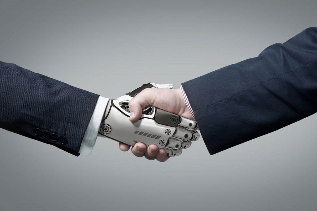 man hand shaking hands with robot hand concept of artificial intelligence