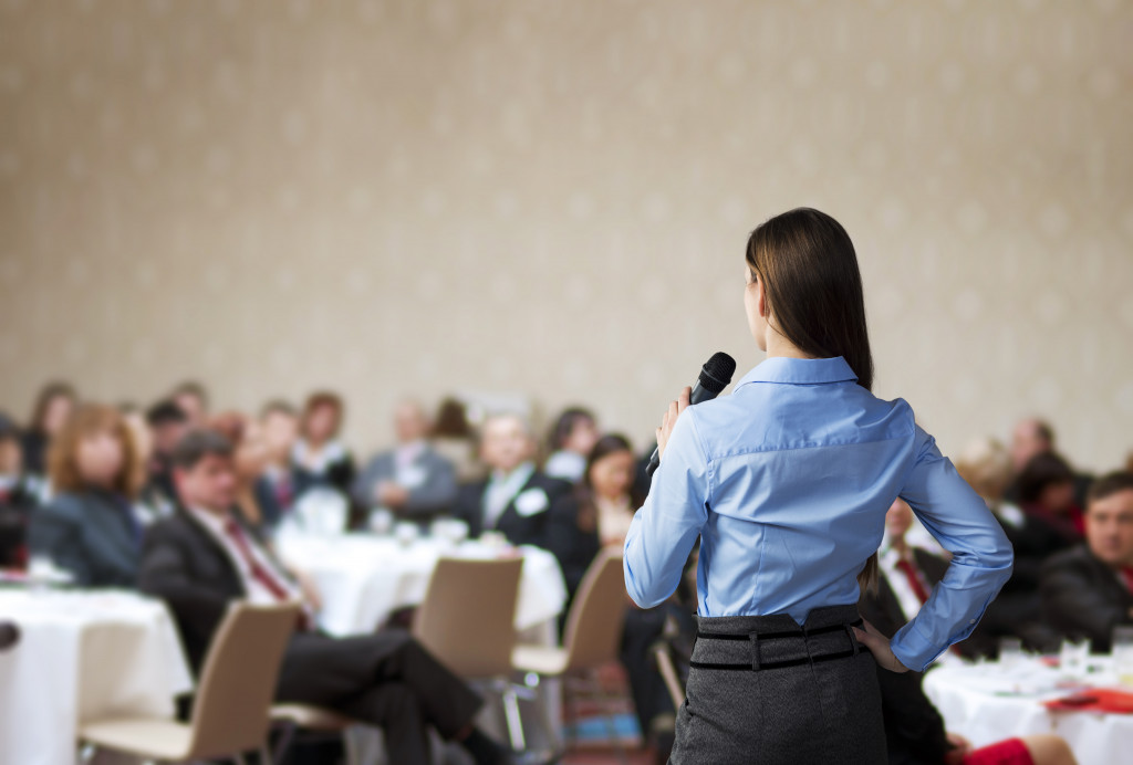 A businesswoman talking in front of a professional audience